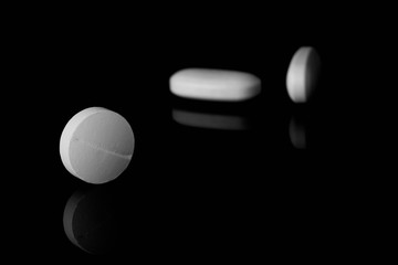 Pills on black background