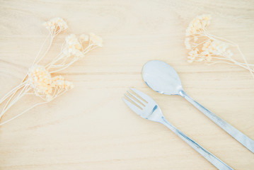 Fork and spoon on wood texture background