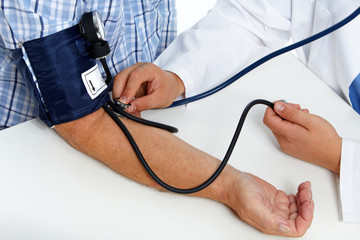Doctor checking patient blood pressure.