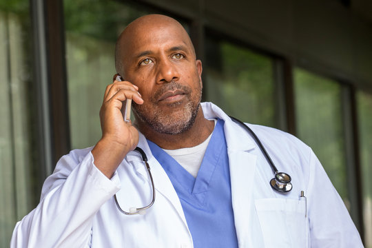 African American Doctor texting on the phone.