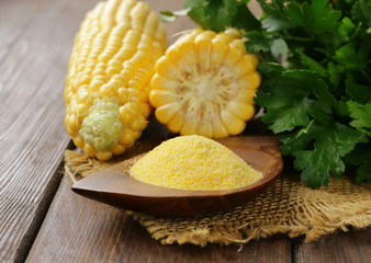 Natural organic corn grits and cobs on the wooden table © Olga Kriger