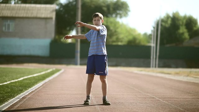 Teenage  boy engaged sport stadium stretching exercises exercise