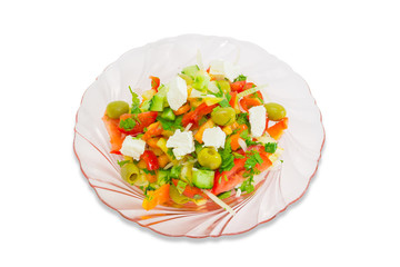 Greek salad on a plate of pink glass