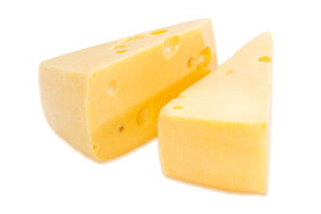 Two pieces of cheese on a light background