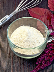Flour amaranth in glass cup on board with mixer