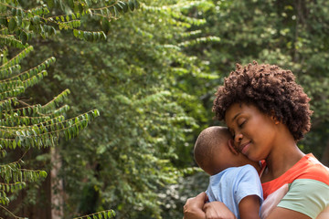 African American mother hugging her son.