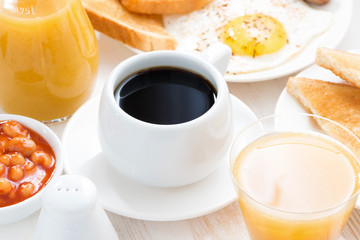 traditional breakfast - coffee, juice, eggs, toast on table