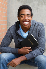Teenage boy holding a Bible.