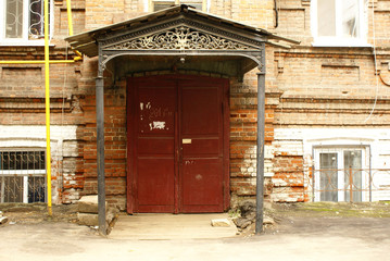 Entrance with forged visor in the old building