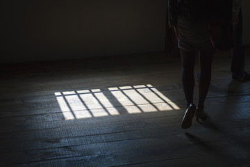 Woman walking in shadows