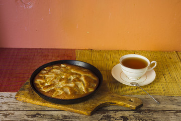 Charlotte. Apple pie with tea