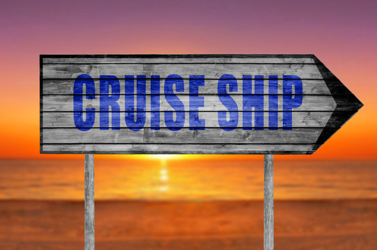 Cruise Ship wooden sign with on a beach background