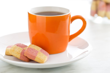 colored butter biscuits with tea mug