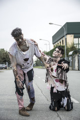 Two male zombies standing in empty city street