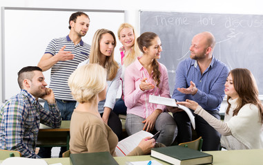 Teacher and happy adult students