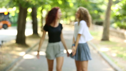 Two beautiful girls walking and laughing at park
- Powered by Adobe