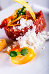 Raw beef .Tasty Steak tartare. Classic steak tartare on white plate with egg bread and cup red wine