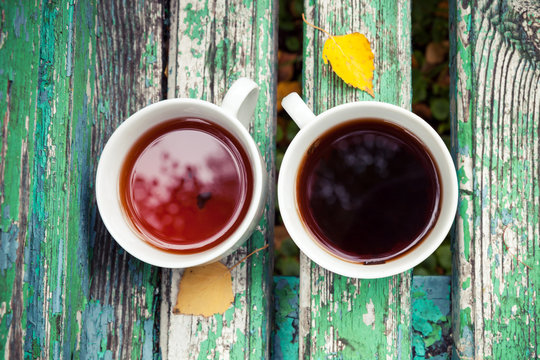 Two Cups Of Tea Is On Old Green Wooden Bench