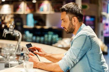 Surfing the net in bar.