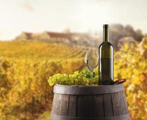 Fototapeta premium White wine bottle and glass on wodden keg