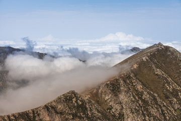 peaks of mountains above the clouds