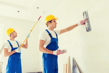 group of builders with tools indoors