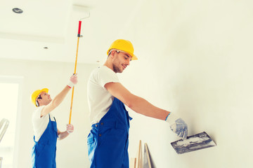 group of builders with tools indoors