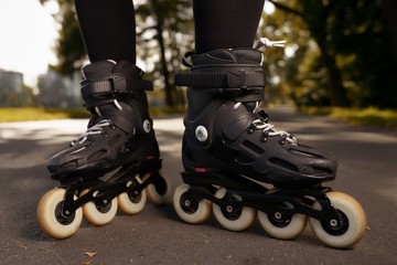 Fototapeta na wymiar Close up view of roller skates on female feet