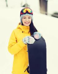 happy young woman with snowboard outdoors