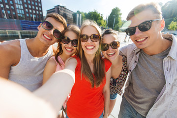 smiling friends taking selfie