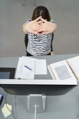frau dehnt die arme am arbeitsplatz