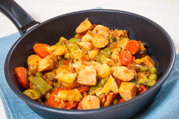 meat stew with mixed vegetables in a frying pan