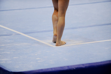 Feet on gymnastics floor