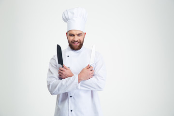Smiling chef cook holding two knifes