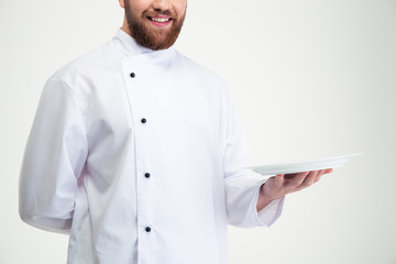 Happy male chef cook holding empty plate