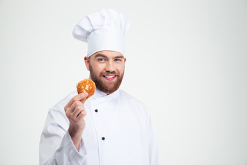 Happy male chef cook holding pancake