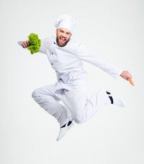 Full length portrait of a cheerful chef cook dancing