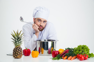 Male chef cook with vegetables on the table