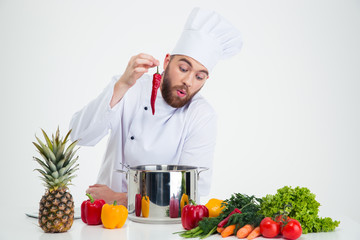 Portrait of a young chef cook preparing soup