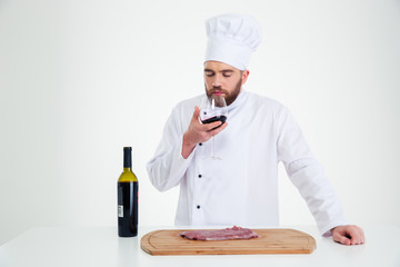 Portrait of a male chef cook degusting wine
