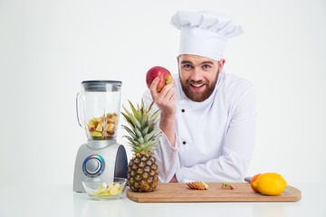 Portrait of a smiling male chef cook with fruits