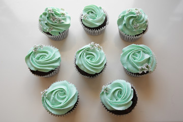 Homemade chocolate cupcake with turquoise rose frosting