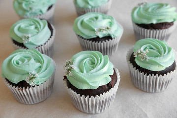 Homemade chocolate cupcake with turquoise rose frosting