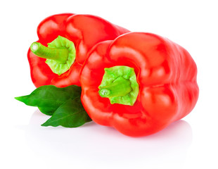 Two bell Red Peppers with green leaves isolated on white backgro