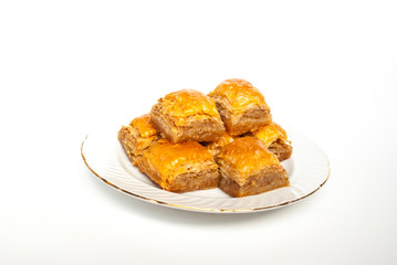 Sweet Baklava on plate isolated on white background.
