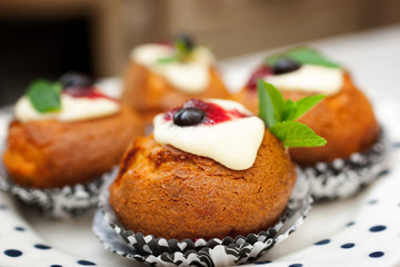 Cakes with ricotta , berries and mint