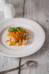 Cod with vegetable sauce on the white wooden  table