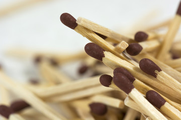matches lying on each other on a white background in a macro view
