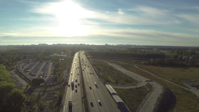 Highway with  car traffic  in evening sunlight. Aerial 