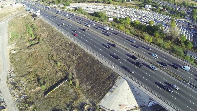 
Highway with  car traffic   and bridge. Aerial  rear fly
